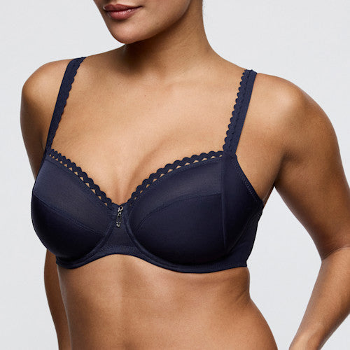 Navy blue bra with lace details on a neutral background