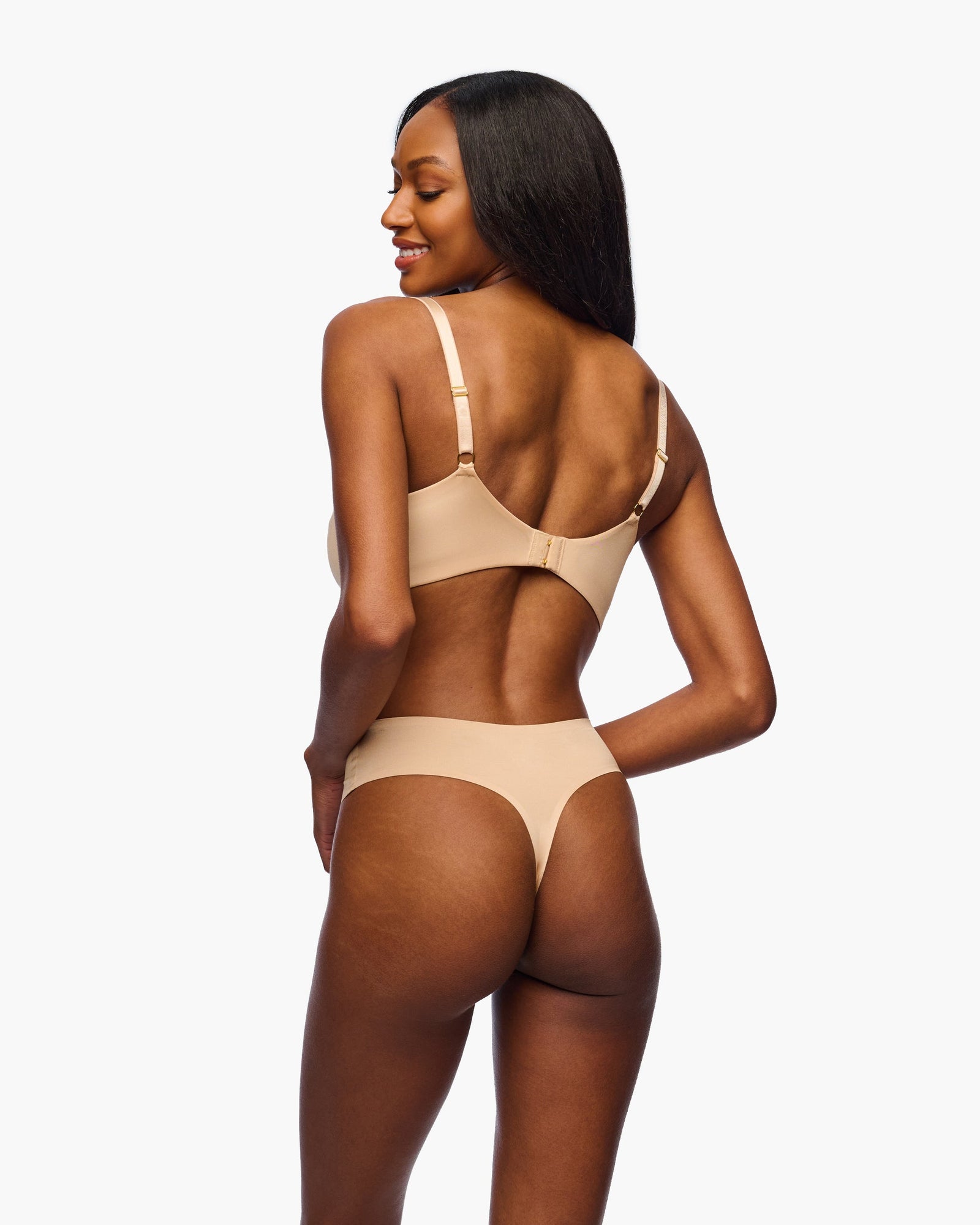 Woman wearing a beige bra on a white background