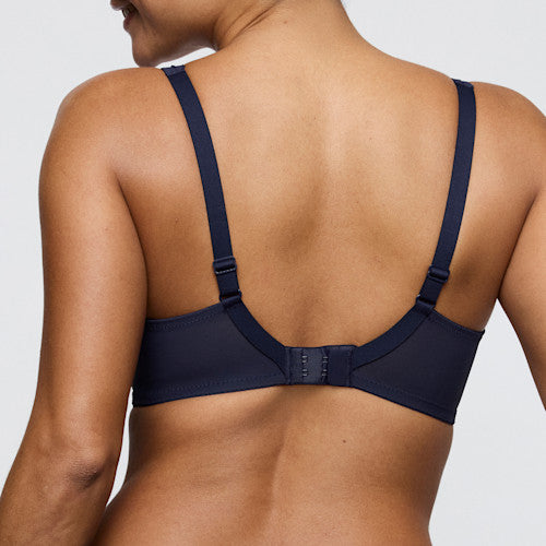 Navy blue bra worn by a person on a light gray background
